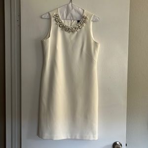 Elegant White Sleeveless Dress with Embellished Neckline